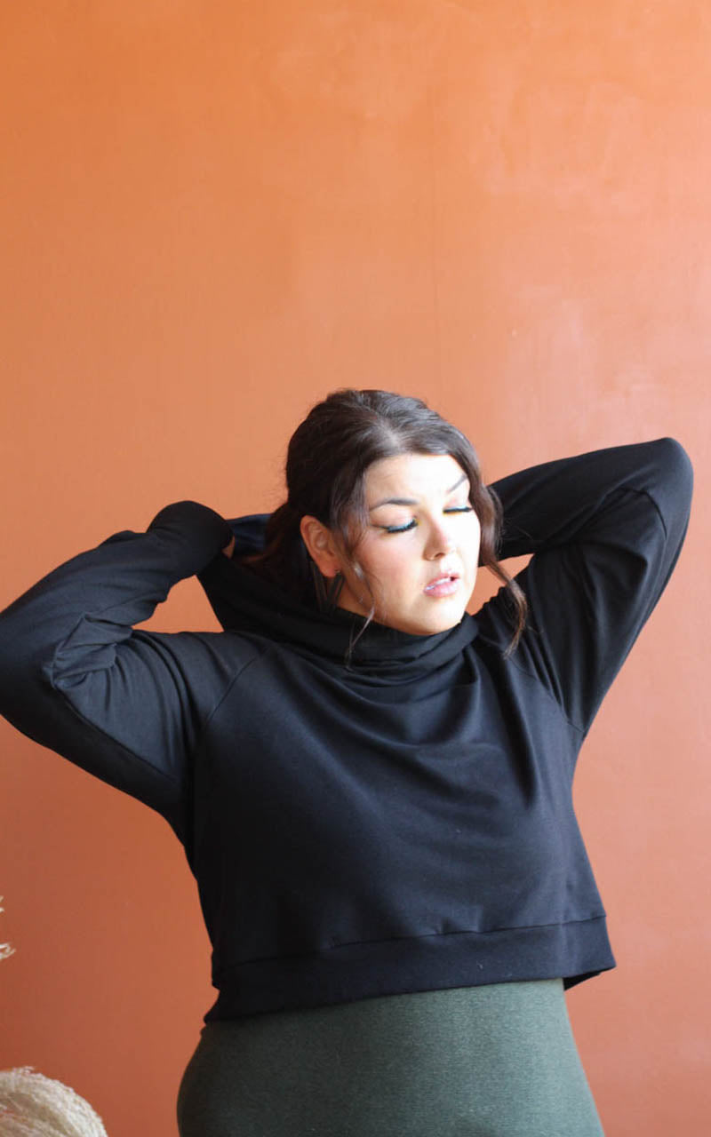 Plus size model adjusting hood of hoodie