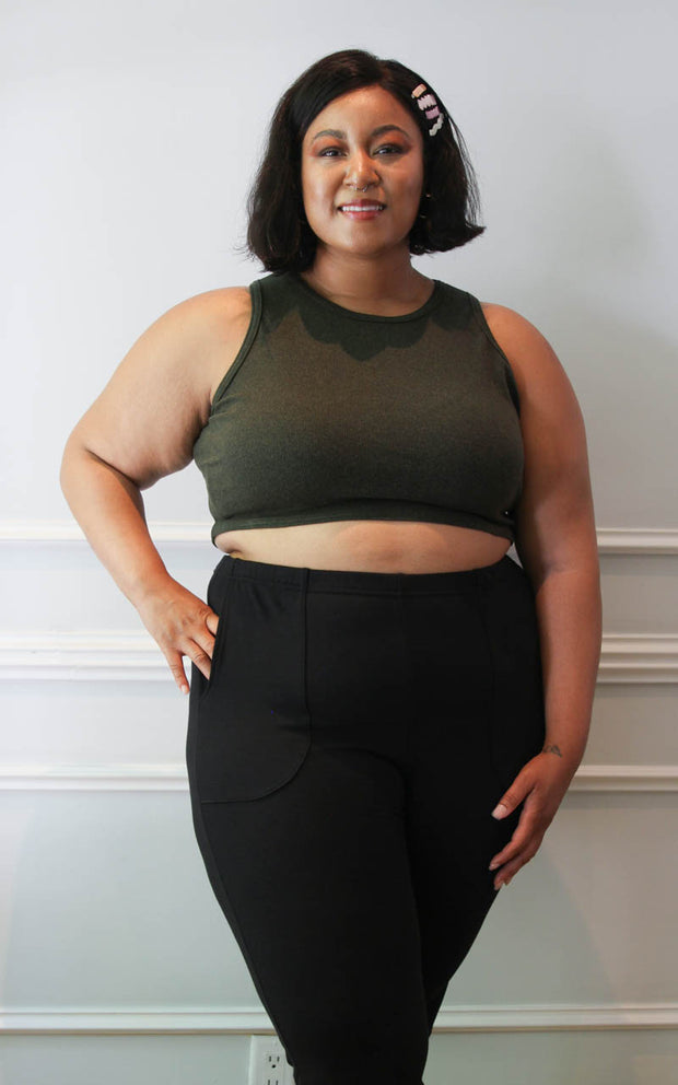 Plus size model wearing a cropped tank and joggers