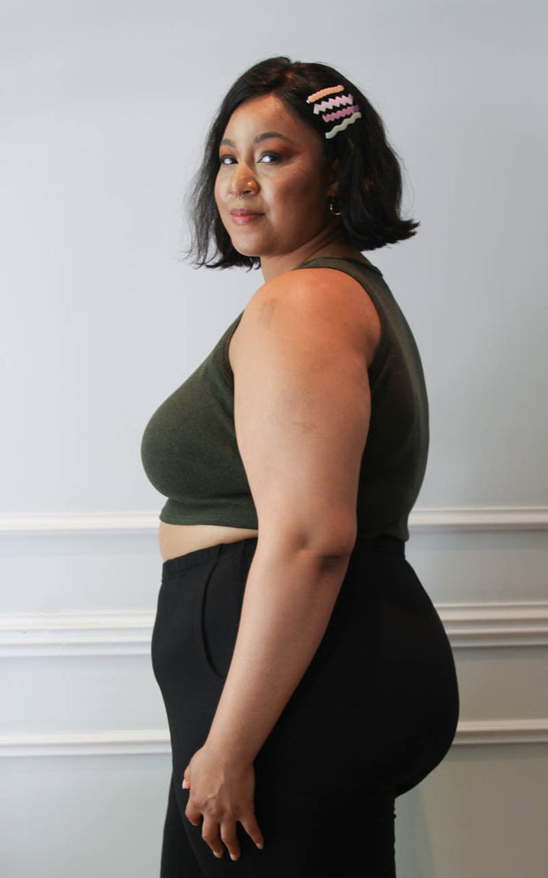 Side view of a plus size model in cropped tank and joggers
