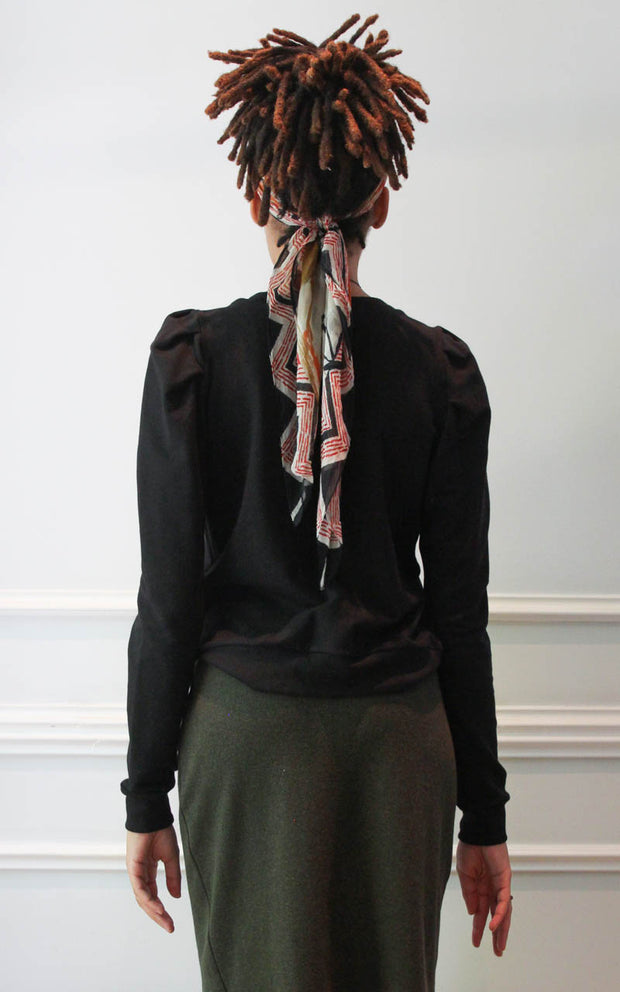 Back view of a model wearing a puff sleeve sweatshirt