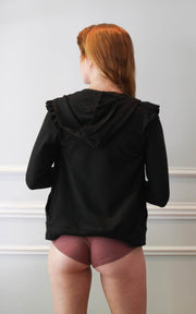 Back view of a model wearing hot pants and hoodie